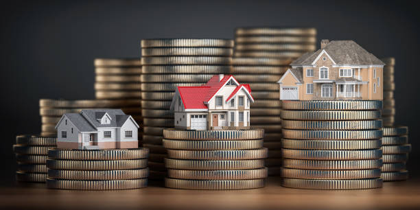 Stacks of coins with miniature houses on top representing different property investments.